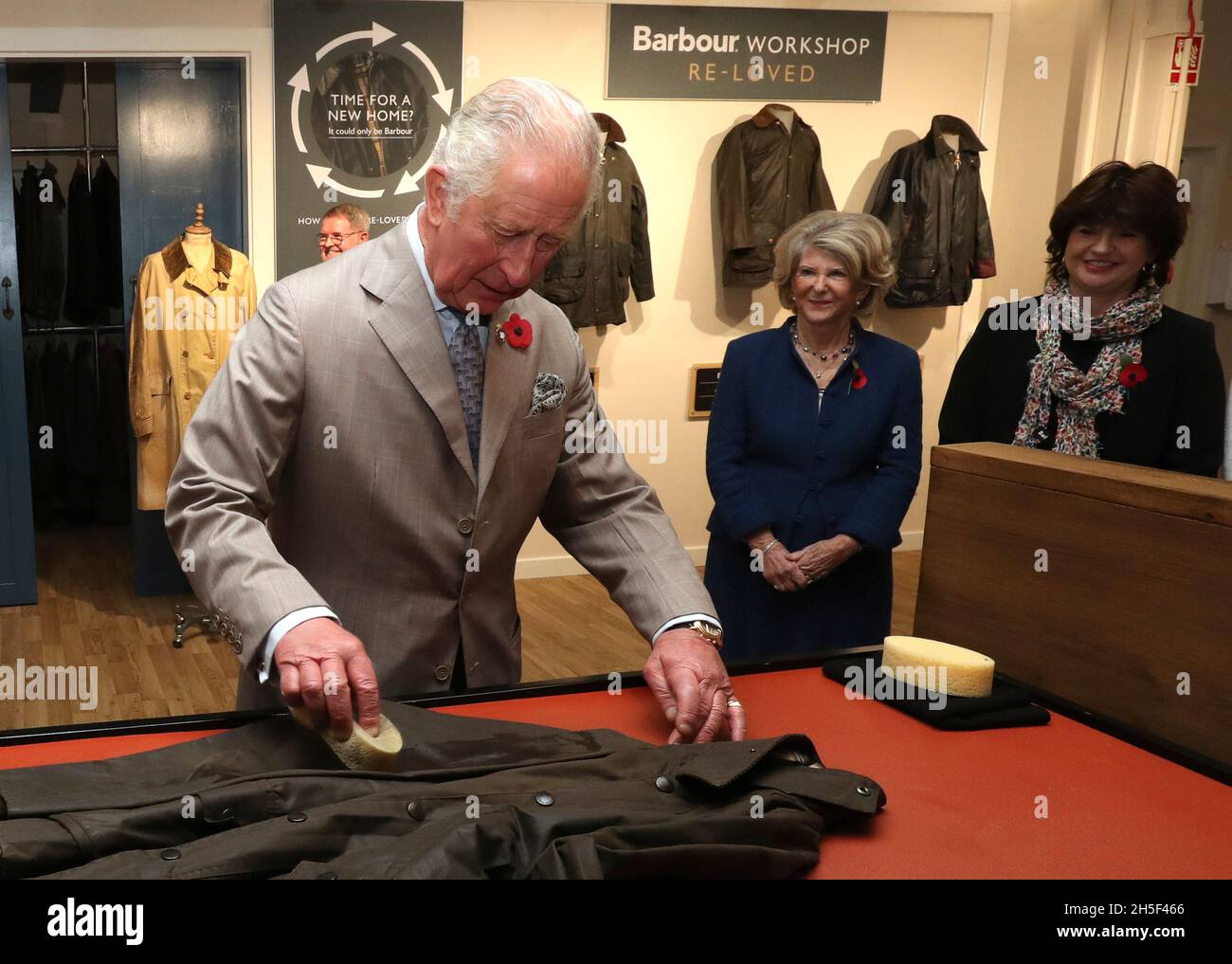 The Prince of Wales tries to reproof a wax jacket during his tour of J  Barbour And Sons Ltd in South Shields, to mark 100 years of sustainability,  during a visit to