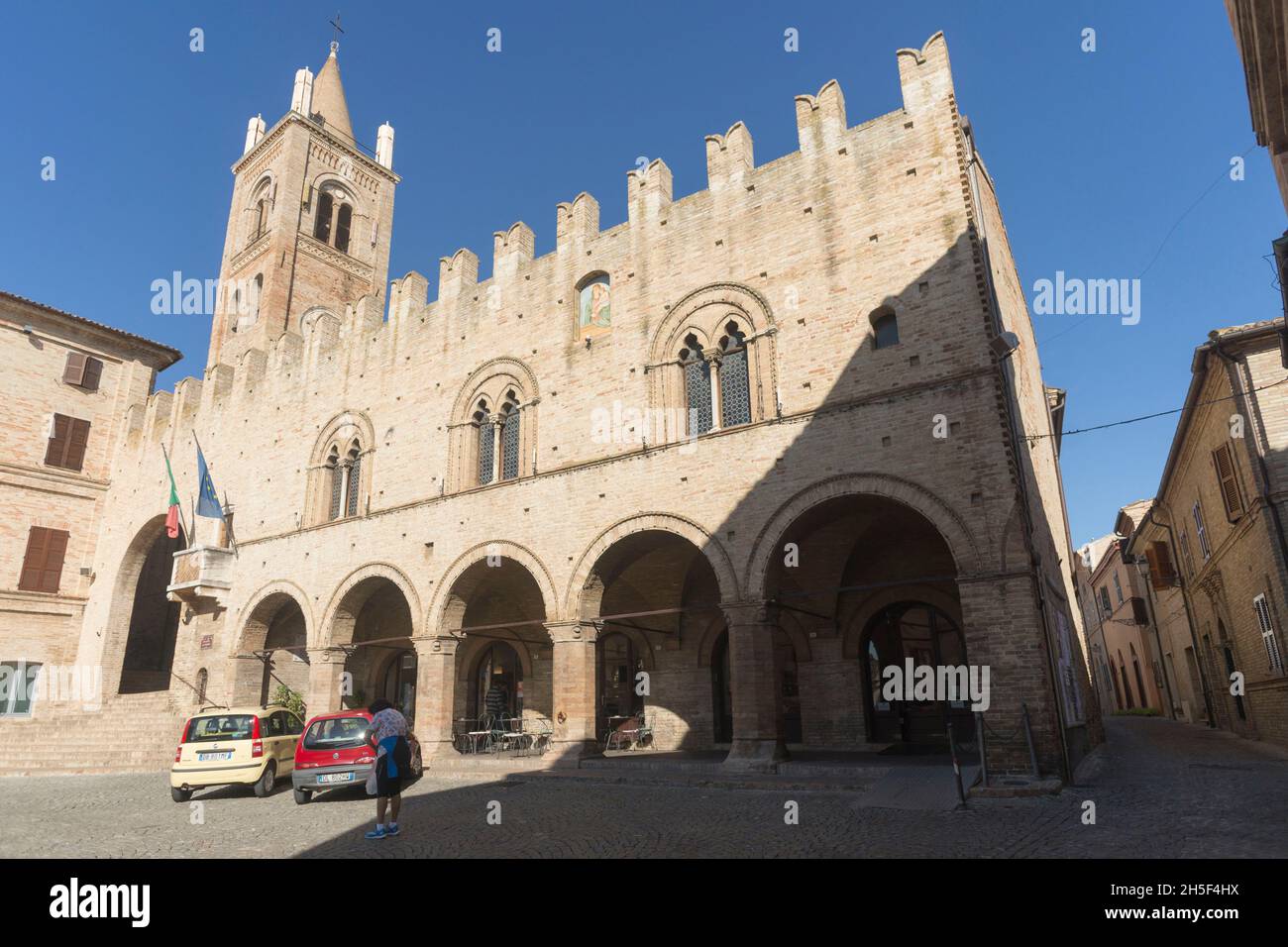 Old Town, Piazza G.Leopardi sqaure, Palazzo dei Priori palace, Collegiate Bell Tower Santa Maria Assunta, Orange Flag, Montecassiano, Marche, Italy, E Stock Photo