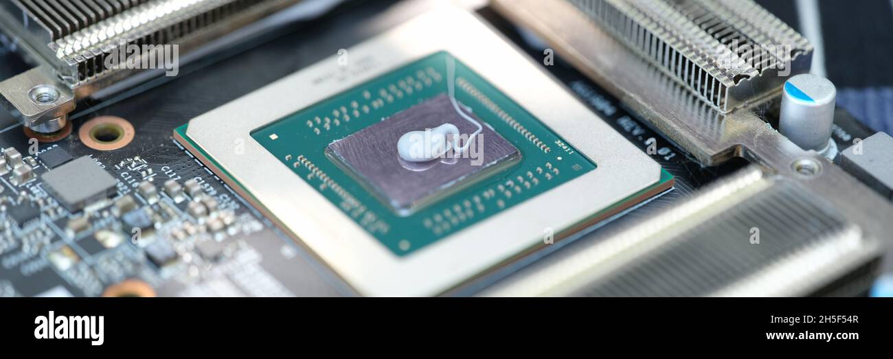 Thermal paste lying on processor from video card closeup Stock Photo