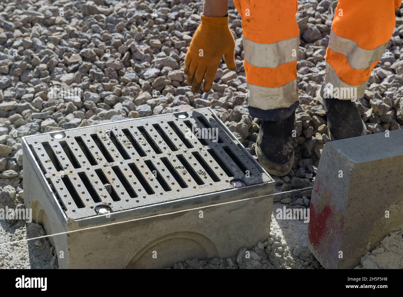 Grate on well a concrete base during the laying water drainage construction Stock Photo