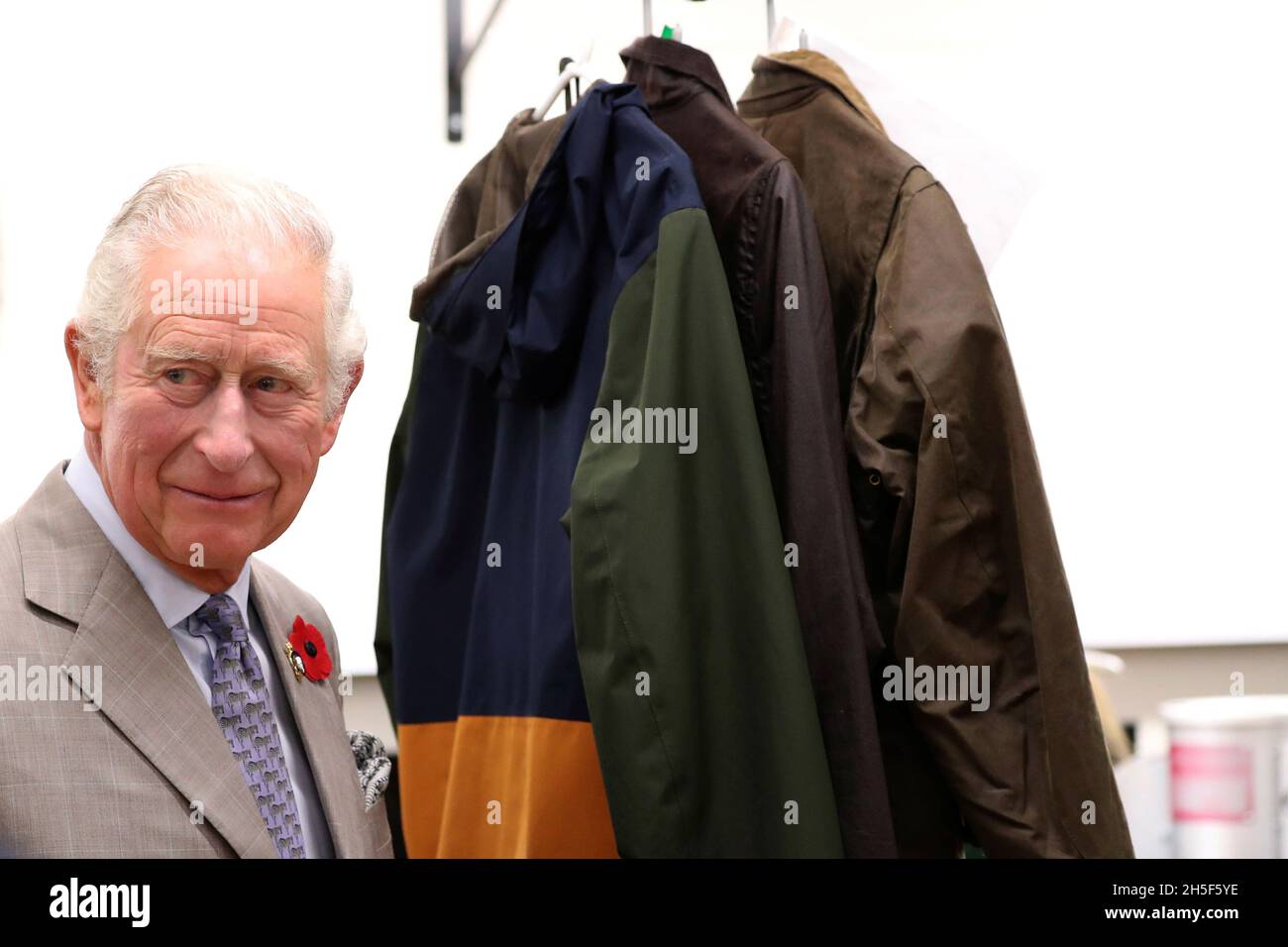 Britain's Prince Charles walks past jackets during a visit to Royal Warrant  Holder, J Barbour And Sons Ltd, in South Shields, Britain November 9, 2021.  Scott Heppell/Pool via REUTERS Stock Photo - Alamy