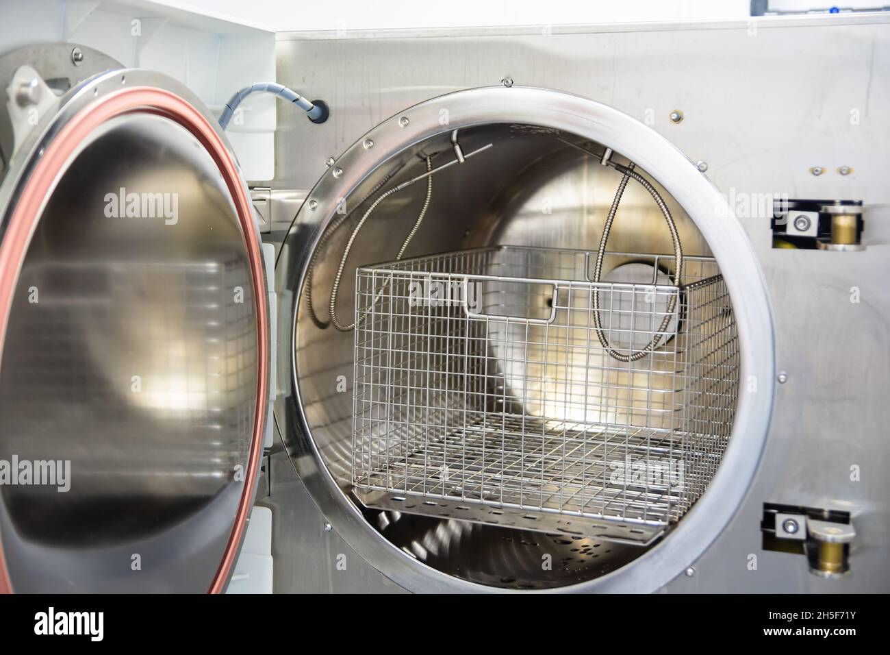 Medical sterilizer. Laboratory technician sterilizes medical