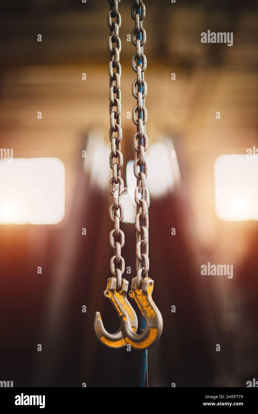 Two iron hooks hang on chains Stock Photo Alamy