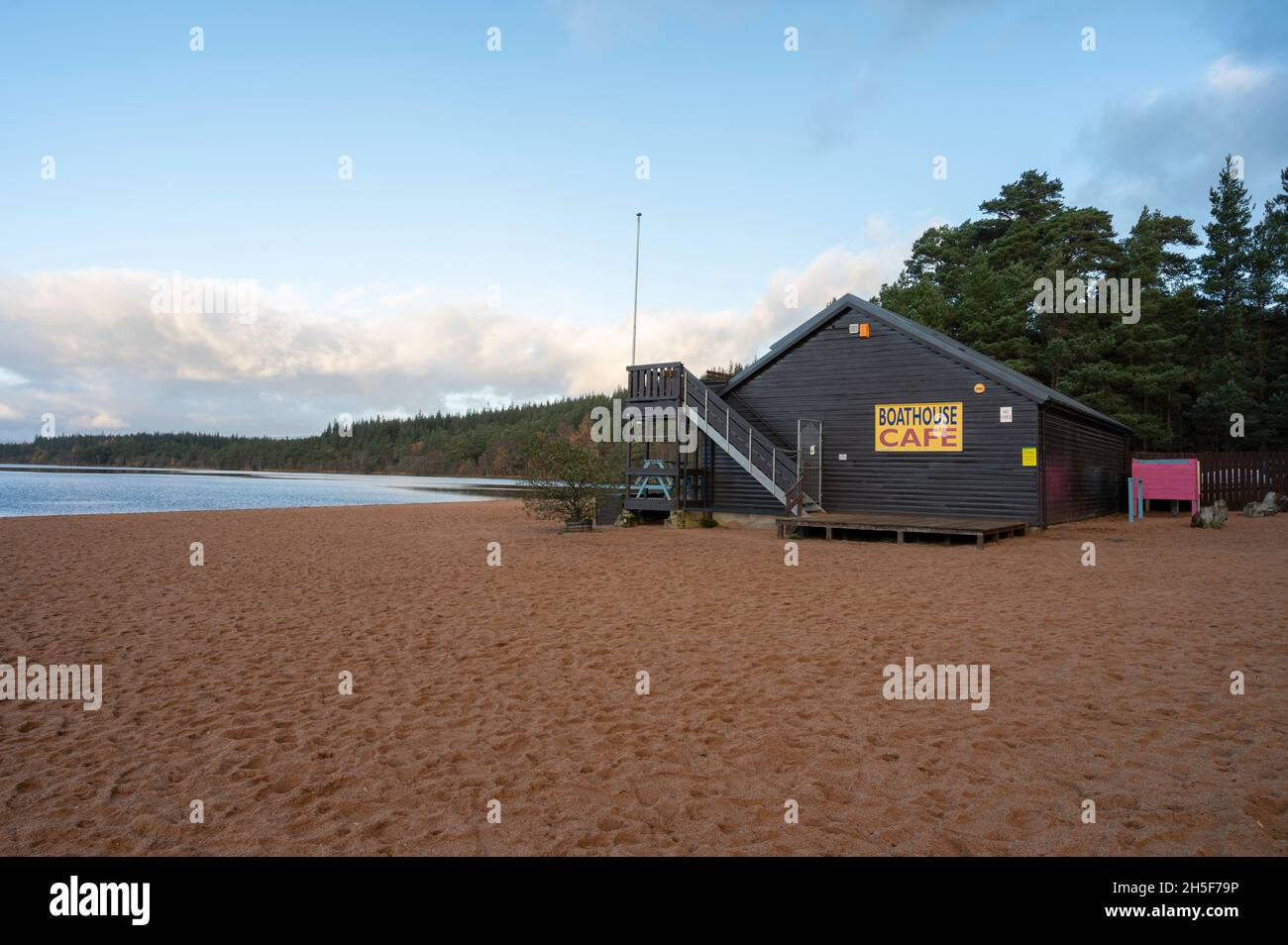 Exterior of Boathouse Cafe on Loch Morlich Beach, Cairngorms National Park. Sunrise, no people. Surrounding landscape of beach, water , forest Stock Photo