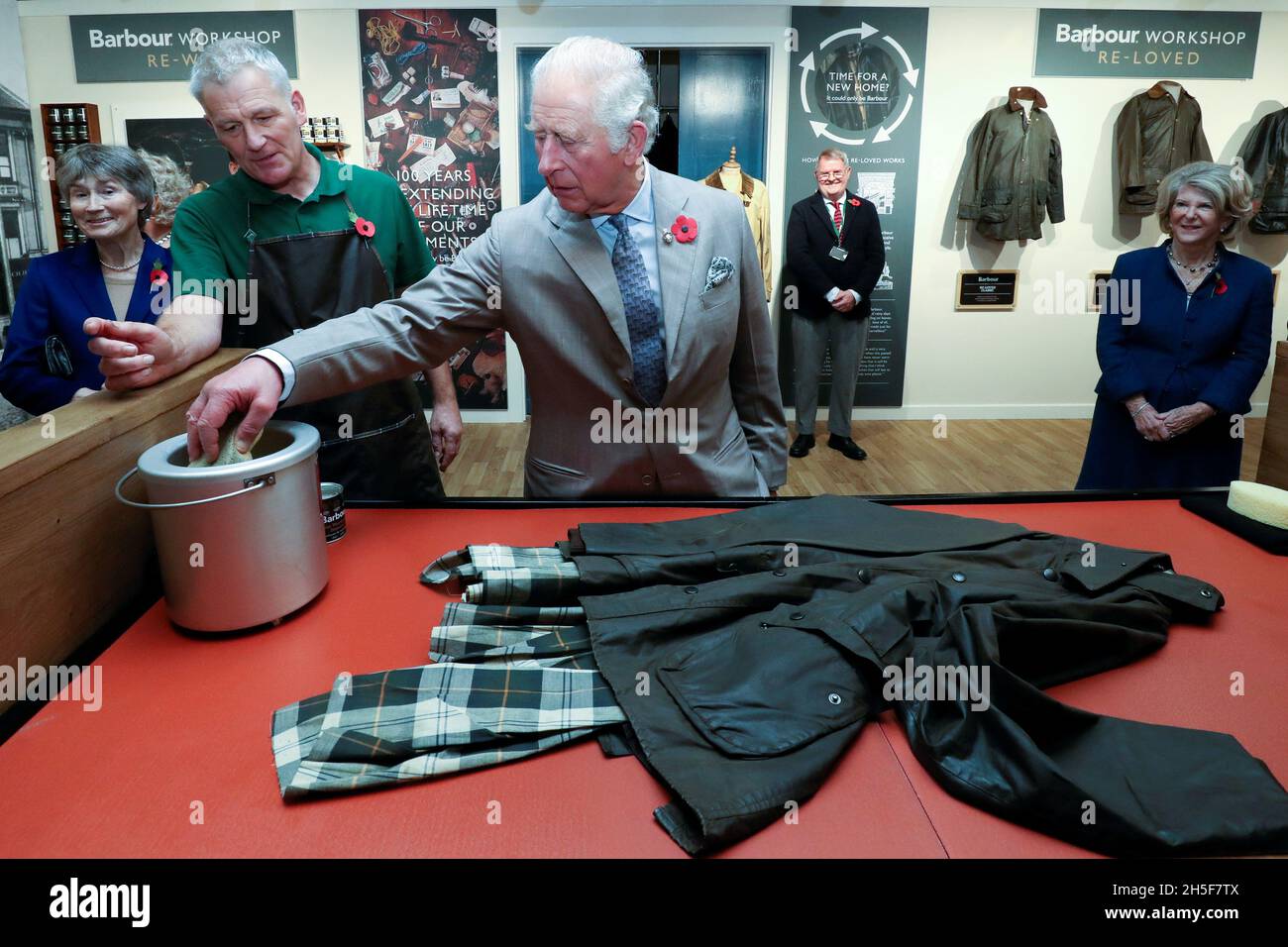 Britain's Prince Charles has a go at reproofing a jacket during his visit  to Royal Warrant Holder, J Barbour And Sons Ltd, in South Shields, Britain  November 9, 2021. Scott Heppell/Pool via