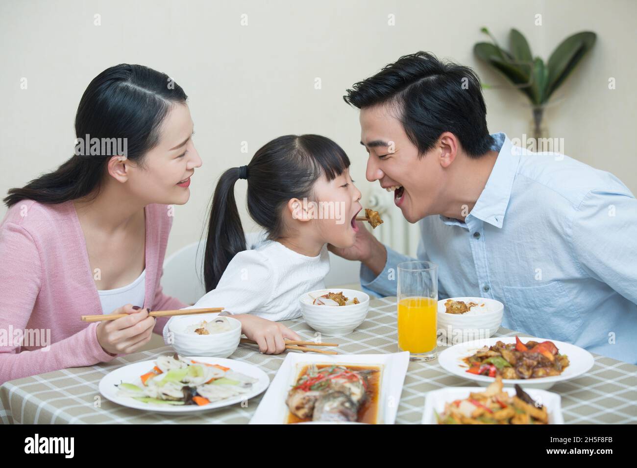 Happy meal for a family of three Stock Photo - Alamy