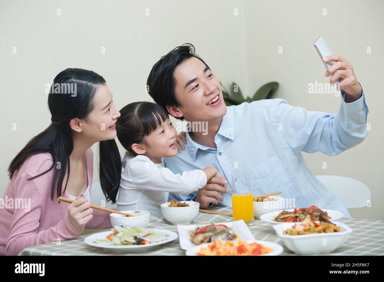 Happy meal for a family of three Stock Photo - Alamy