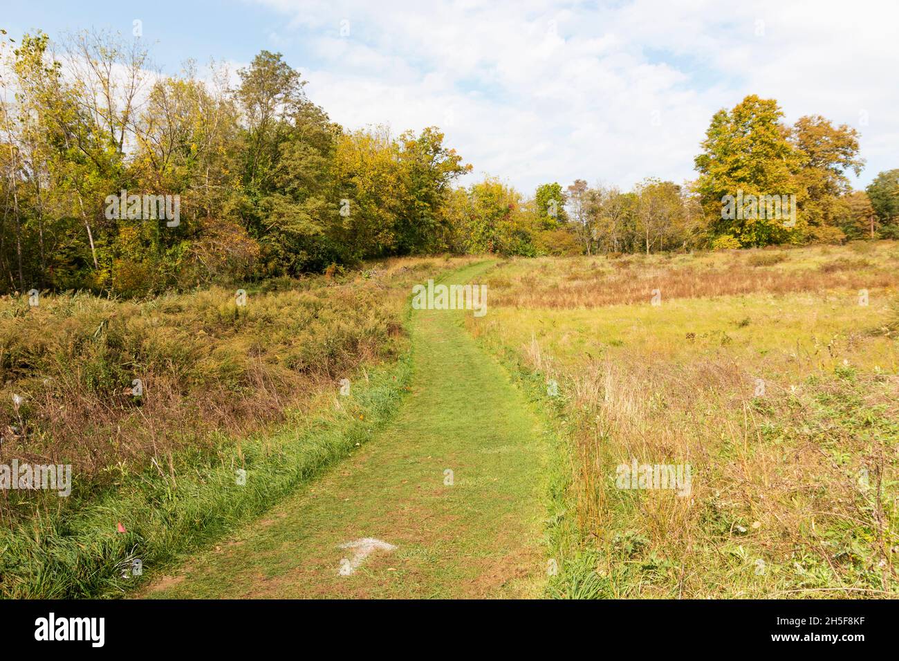 A well maintained empty cross country runners course on a grass field