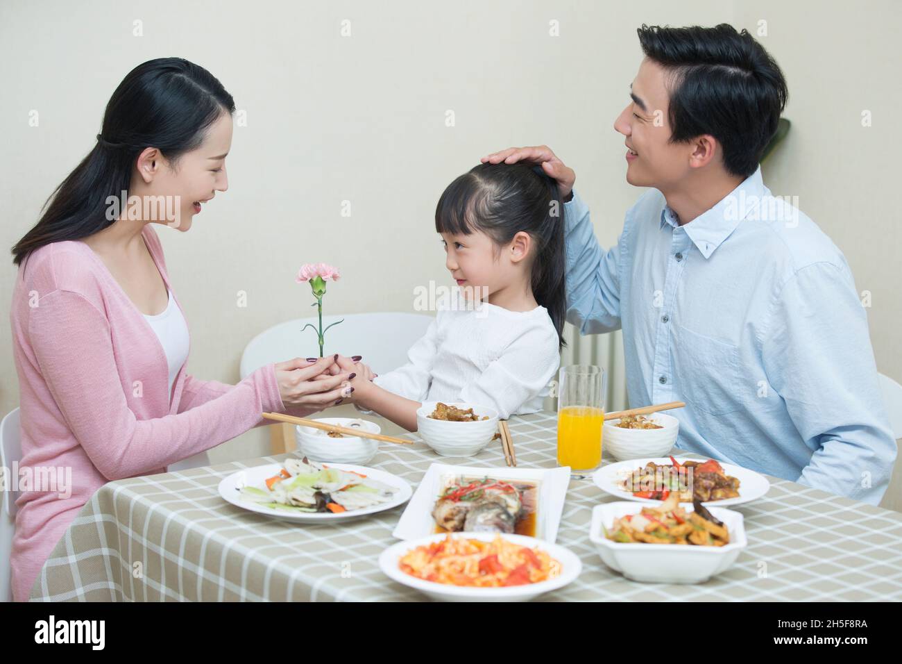 Happy meal for a family of three Stock Photo - Alamy