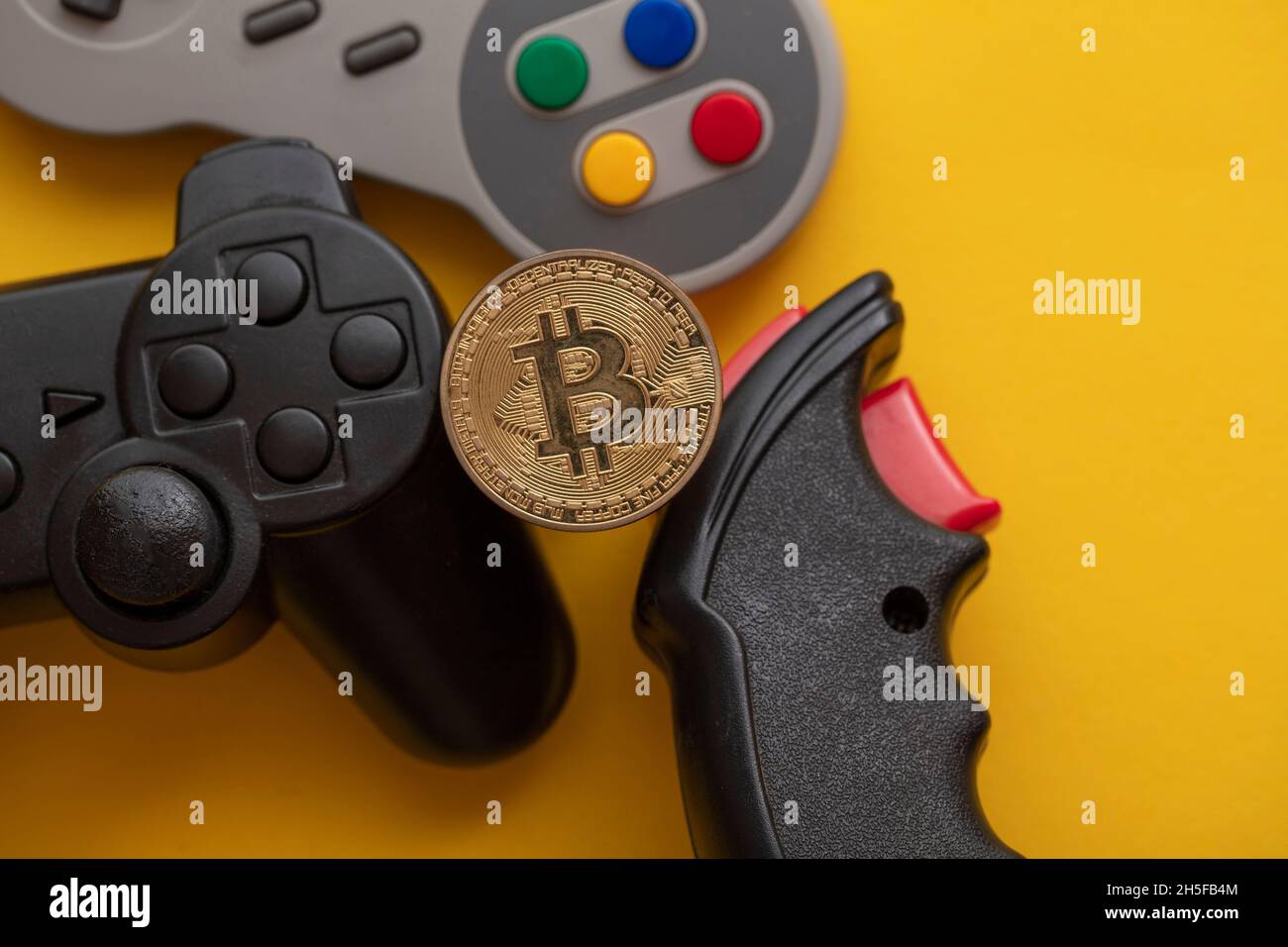 Crypto gaming concept. Video game controller with a bitcoin cryptocurrency  coin Stock Photo - Alamy