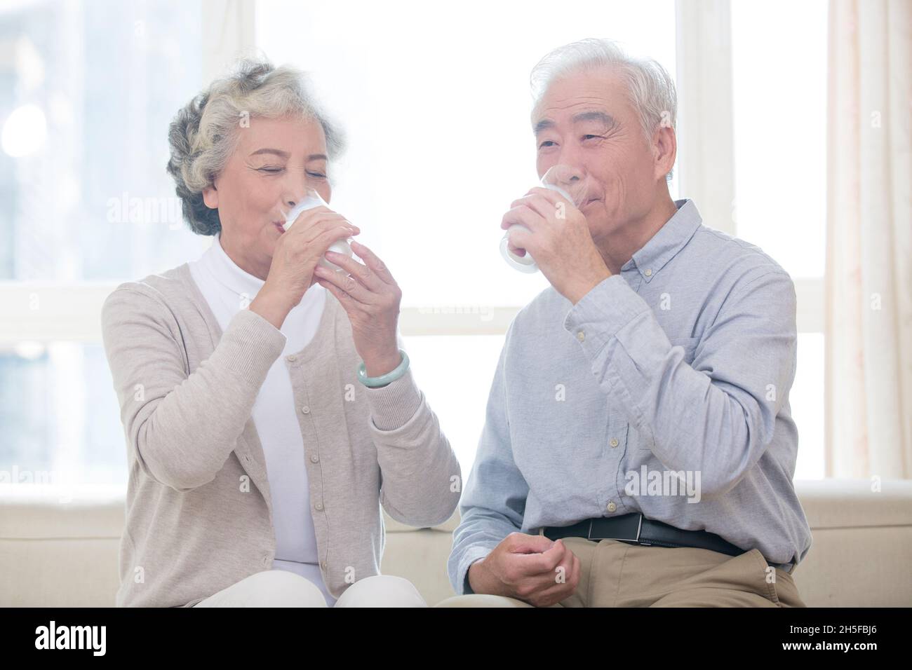 Happy old couple drinking milk Stock Photo Alamy