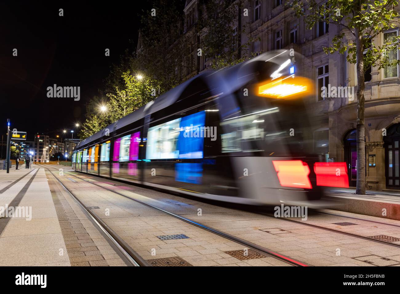 Blurred public transport tram in Luxembourg city coming from the central train station (Gare centrale) Stock Photo