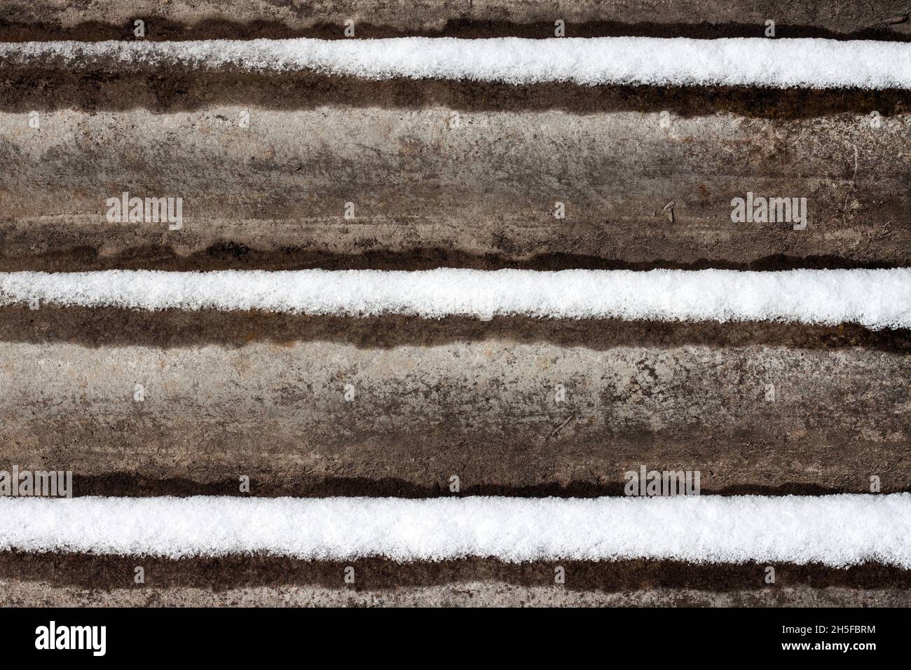 Slate background with snow lying on it. Stock Photo
