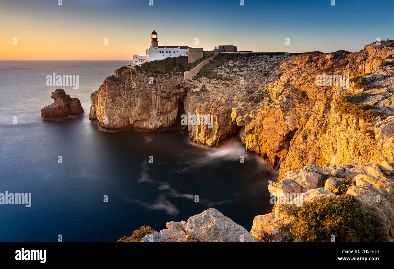 The lighthouse of Cabo Sao Vicente stands on a rocky outcrop on the coast of the Algarve region. It marks the southwestern point of Portugal. Stock Photo