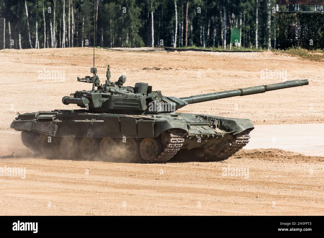 Military or army tank ready to attack and moving over a deserted battle ...