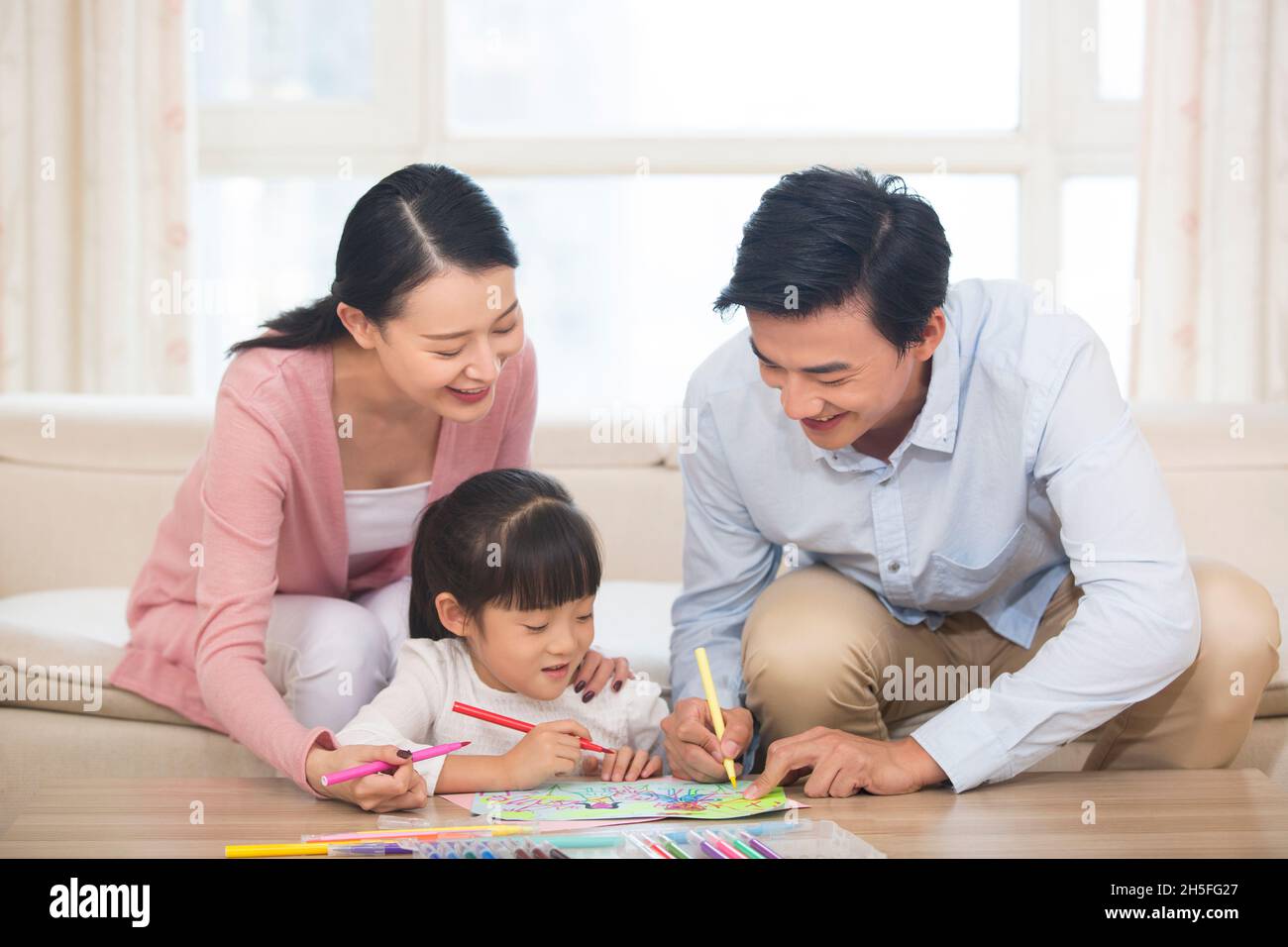 Happy family of three drawing pictures Stock Photo
