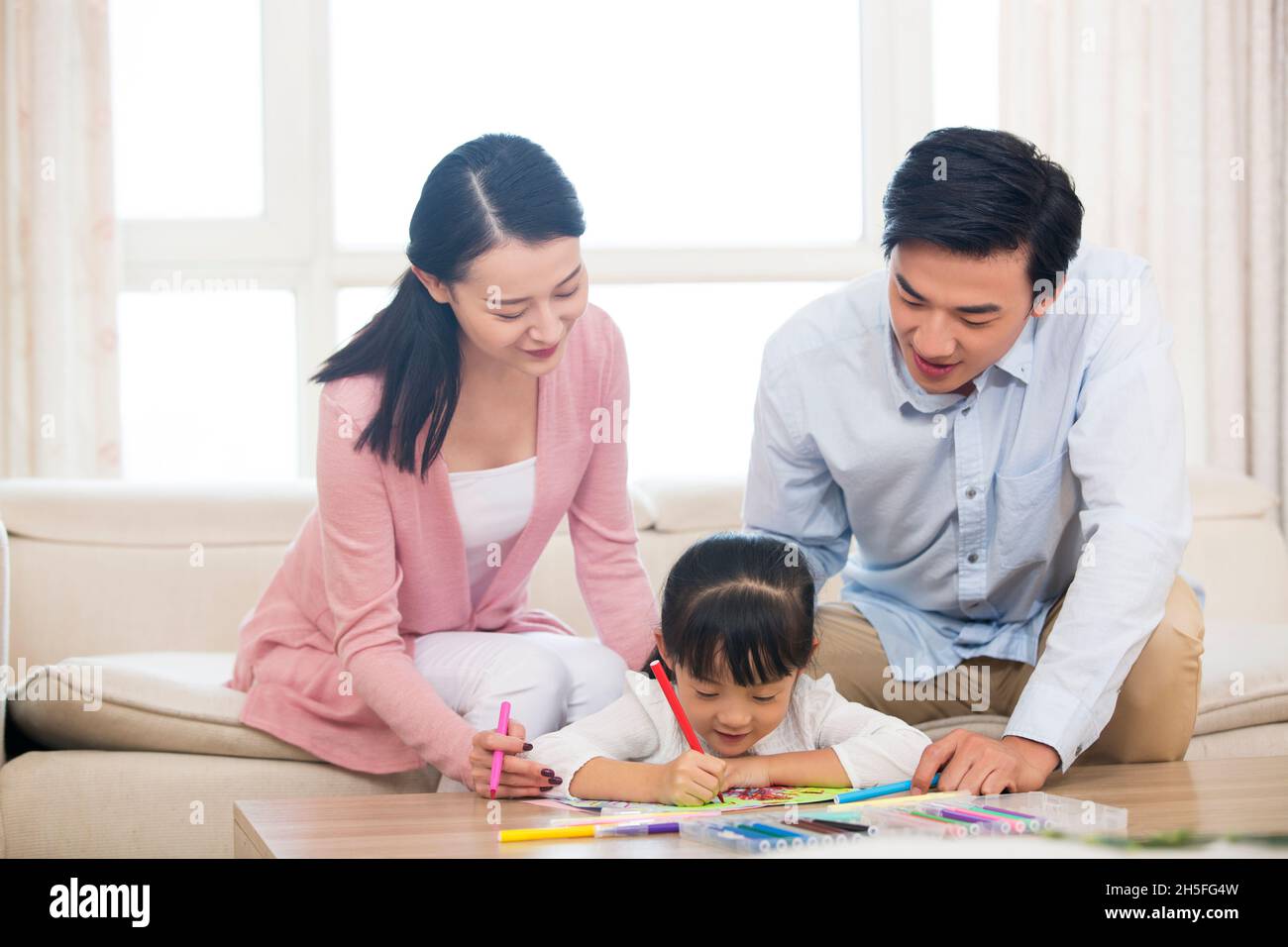 Happy family of three drawing pictures Stock Photo