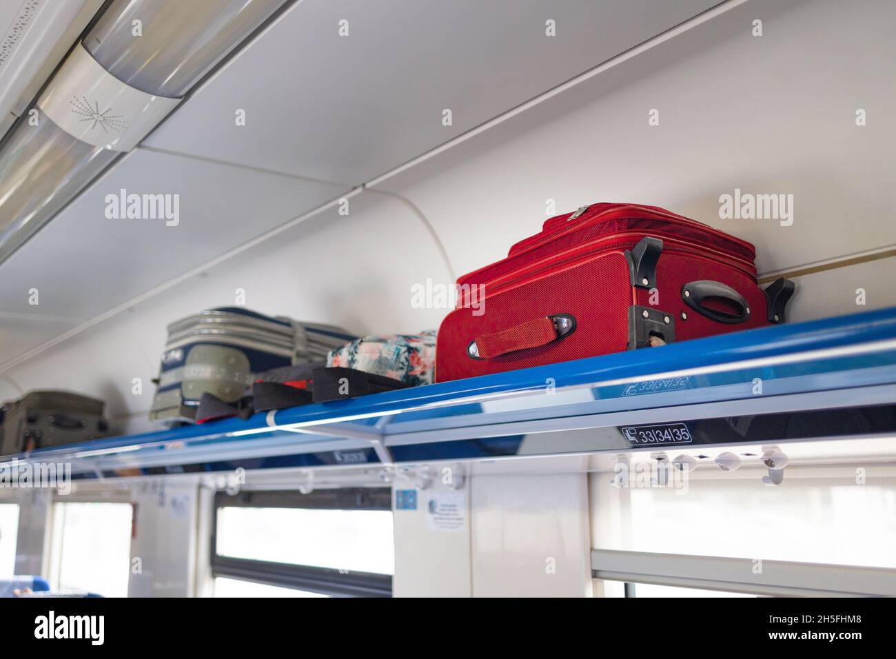 Lots of suitcases and carryon bags in the luggage compartment of the