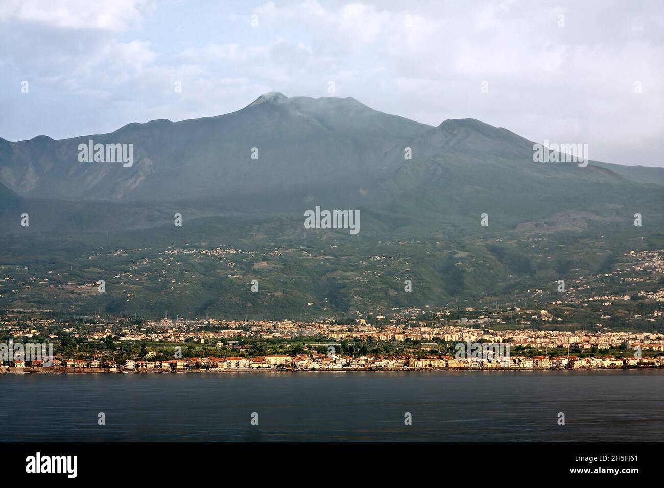 Mount Etna, Europe's largest active volcano, many buildings below, town ...