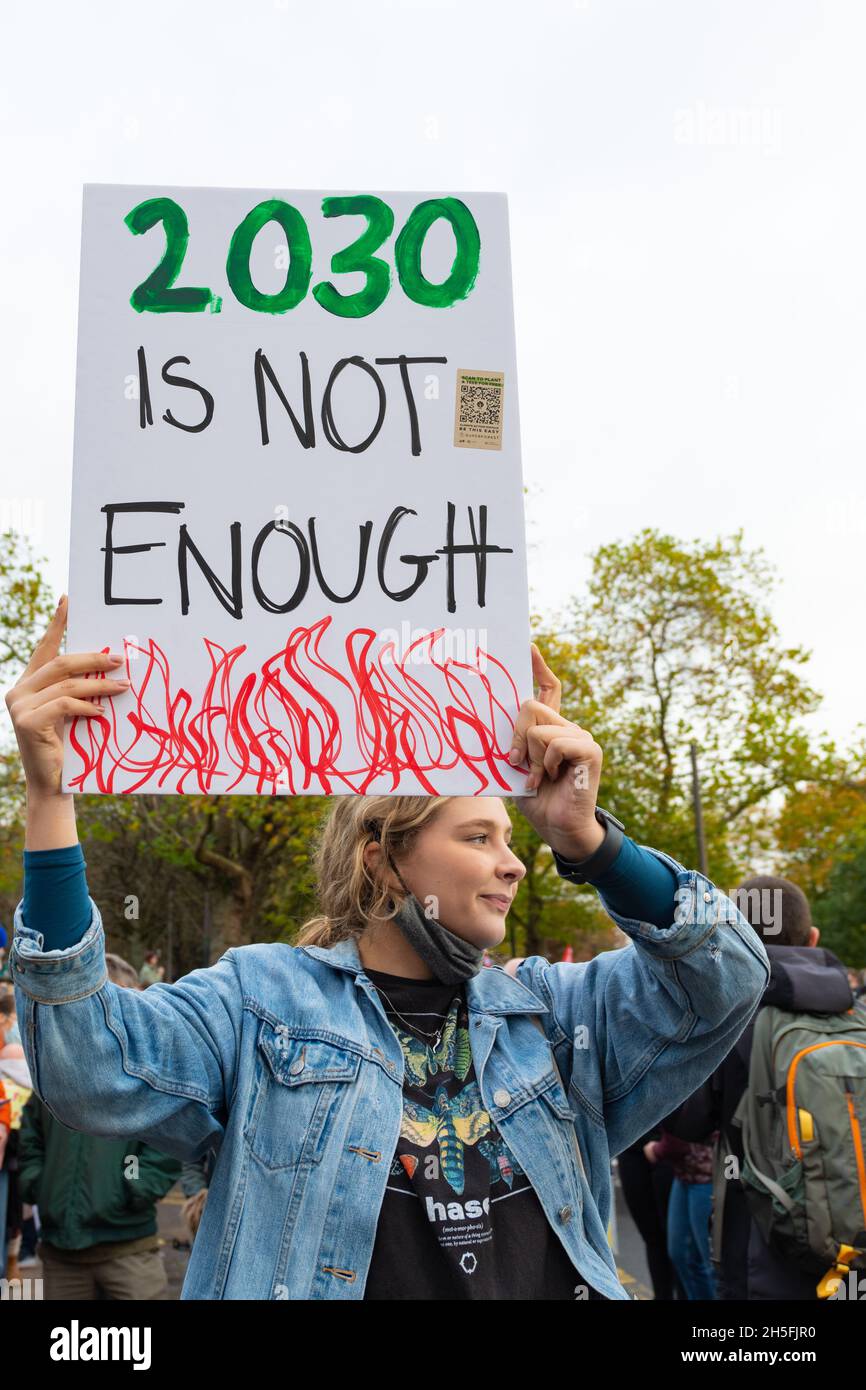 2030 climate targets - young woman holding a 2030 is not enough sign during Fridays for Future march during COP26 Glasgow, Scotland, UK Stock Photo
