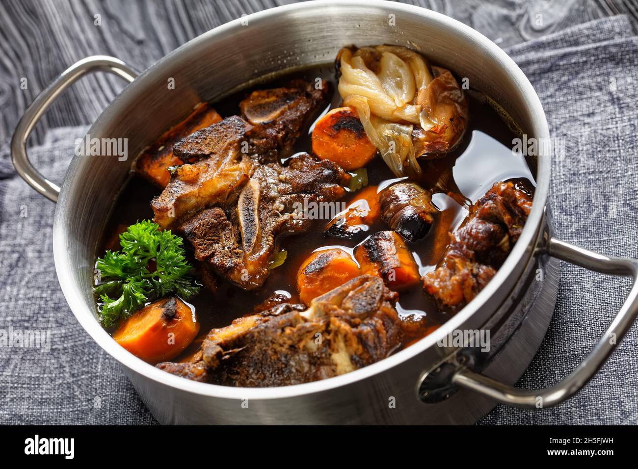 beef broth of beef meat on bones slow cooked with charred vegetables