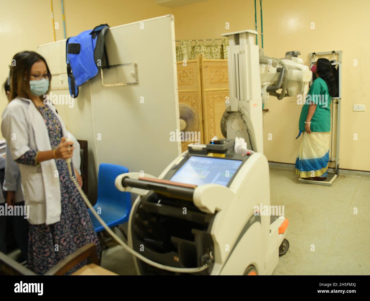 A radiographer prepares a patient for an Xray in G. B. Pant hospital