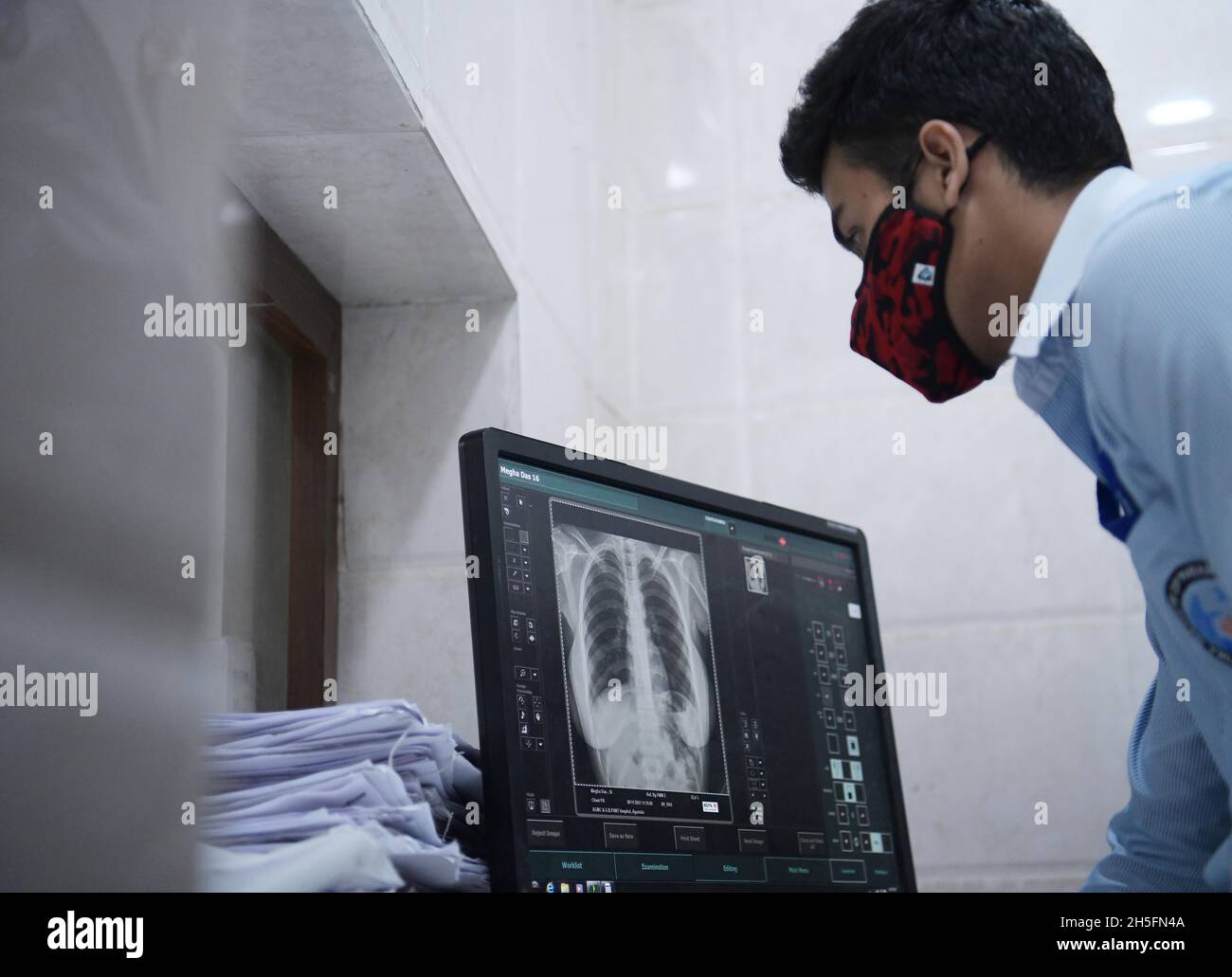 A radiographer prepares a patient for an X-ray in G. B. Pant hospital ...
