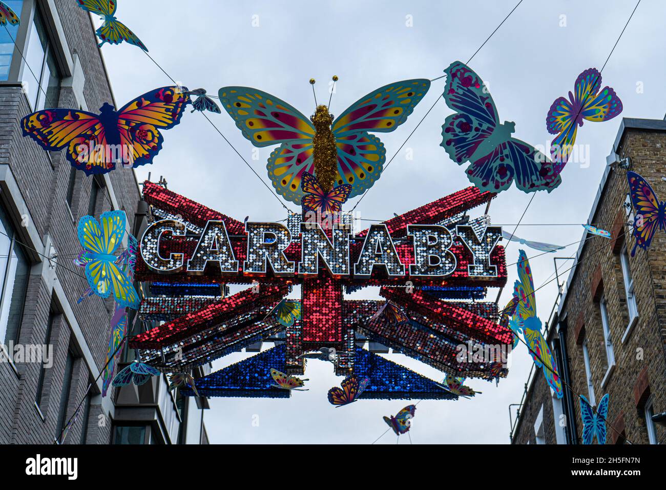 London UK. Carnaby Street is decorated  this year with a theme Kaleidascope and an array of multicoloured butterflies fluttering overhead Stock Photo