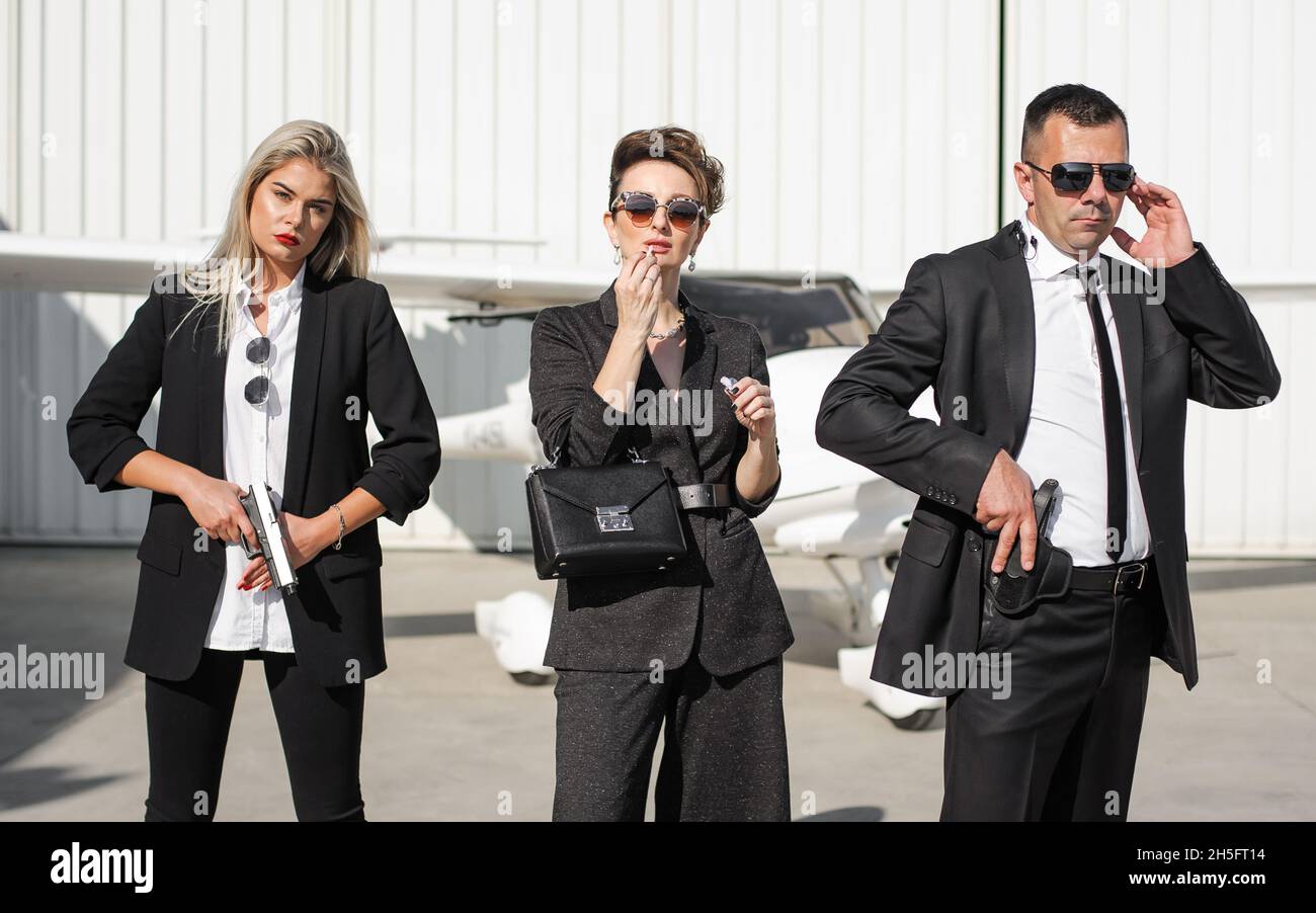 Celebrity bodyguard and VIP person security close protection services. Professional police agent special forces with sunglasses in civilian black suit Stock Photo