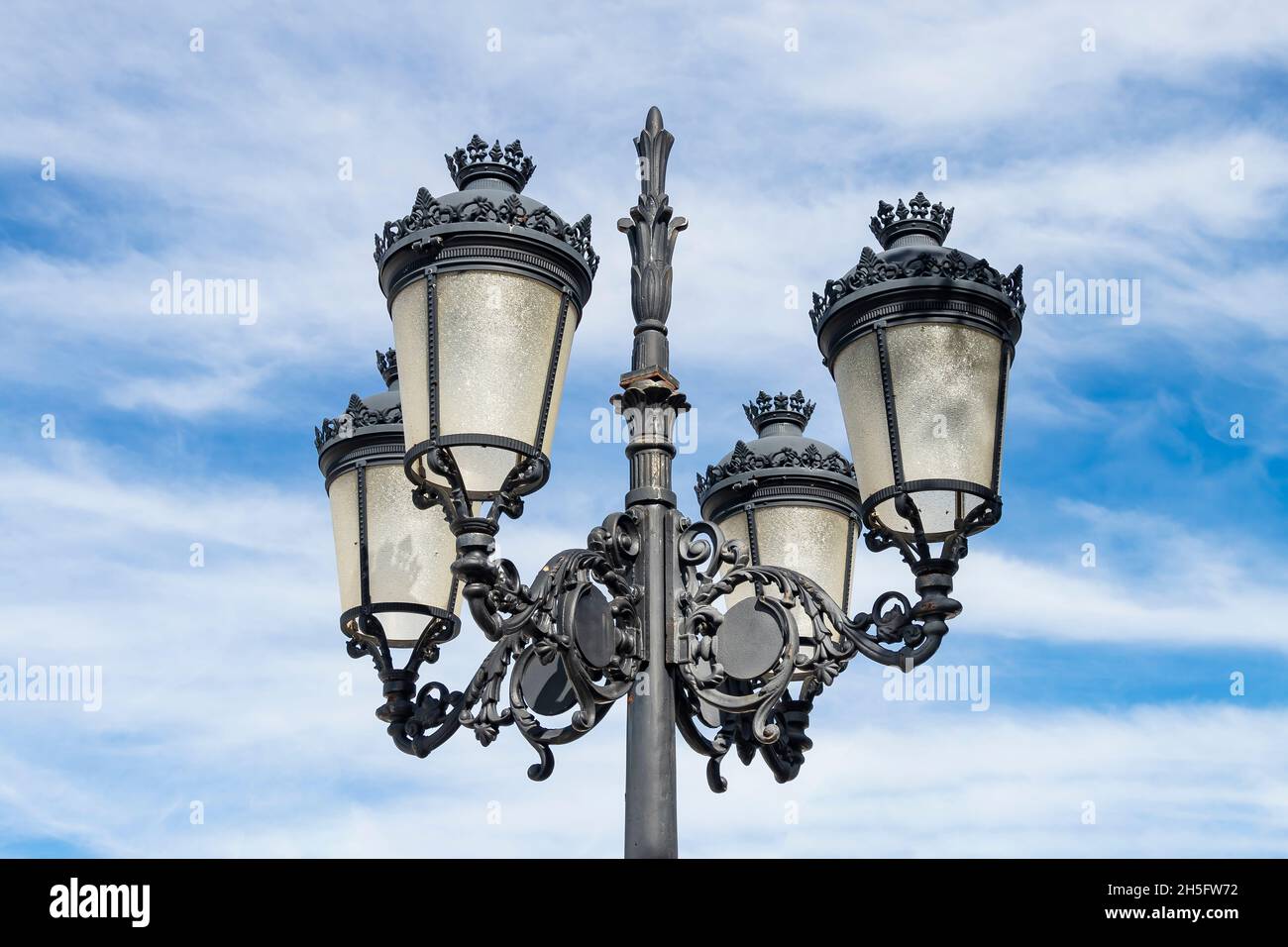 View of a typical Andalusian streetlight with four lights Stock Photo