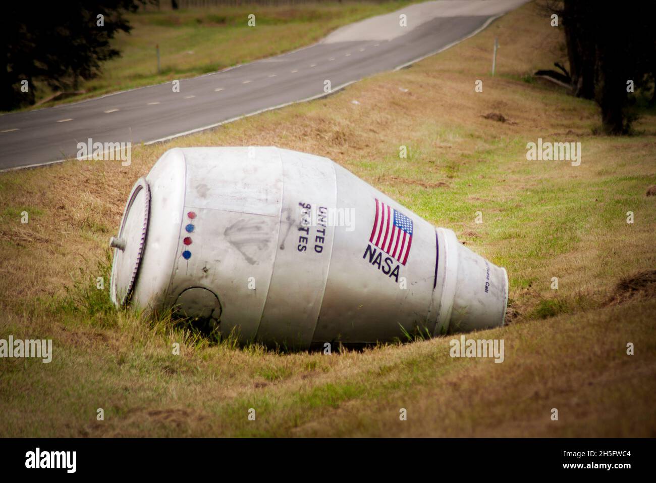 09 12 2020 USA - Oklahoma kitch - Cement mixer space shuttle laying in a roadside ditch in northern Rogers County Stock Photo