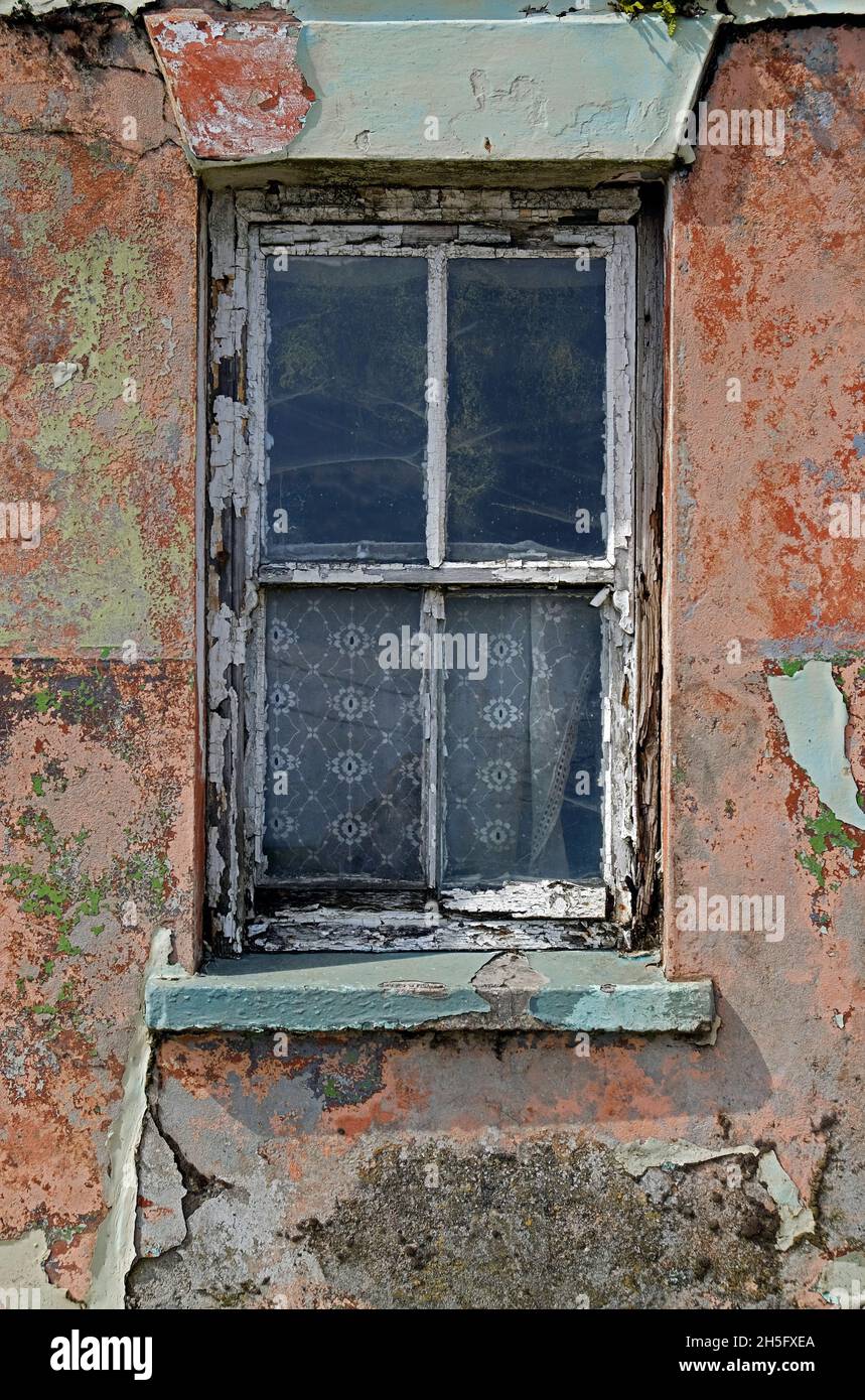 Shabby window of an ancient abandoned house in West Cork Ireland, Republic Stock Photo