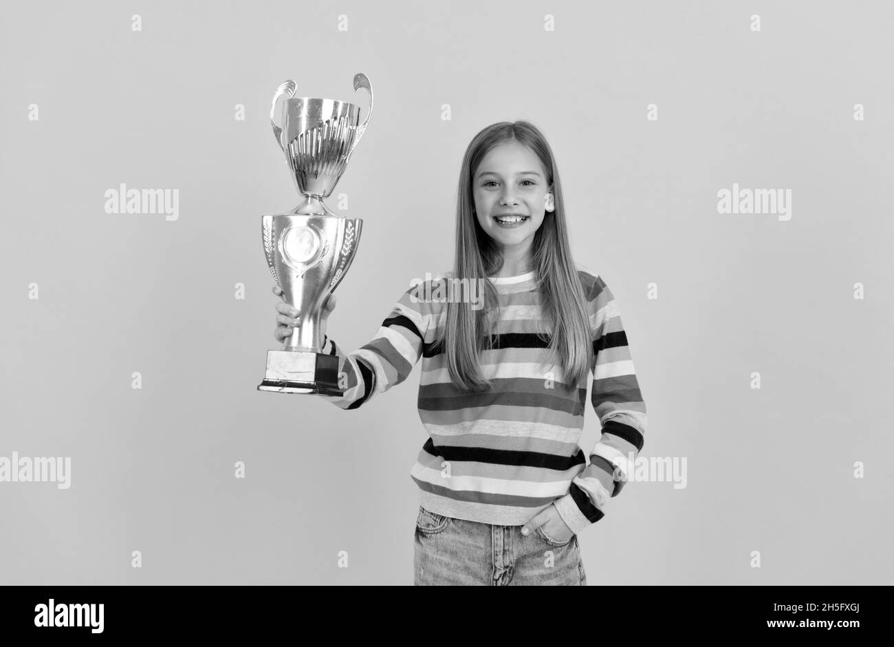 Happy child hold golden cup. achievement award. Celebrating school success. Stock Photo