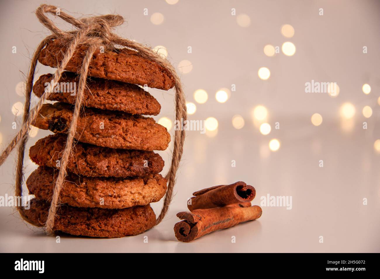 Close up of oatmeal cookies in a stack tied with brown thread and ...