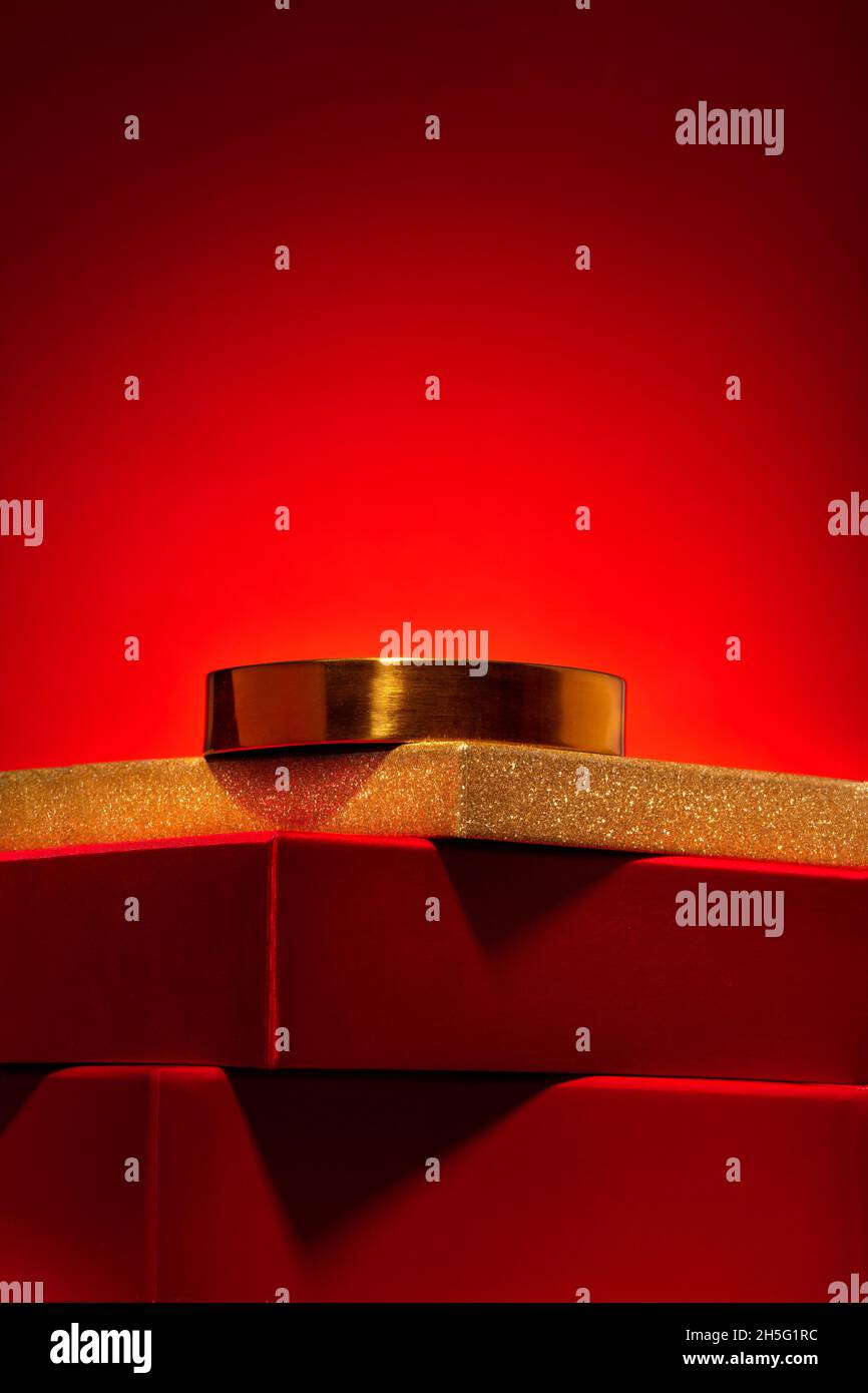 Majestic empty red podium made of gift boxes and a golden circle on a red background. Pedestal, showcase for products and cosmetics. Chinese New Year Stock Photo