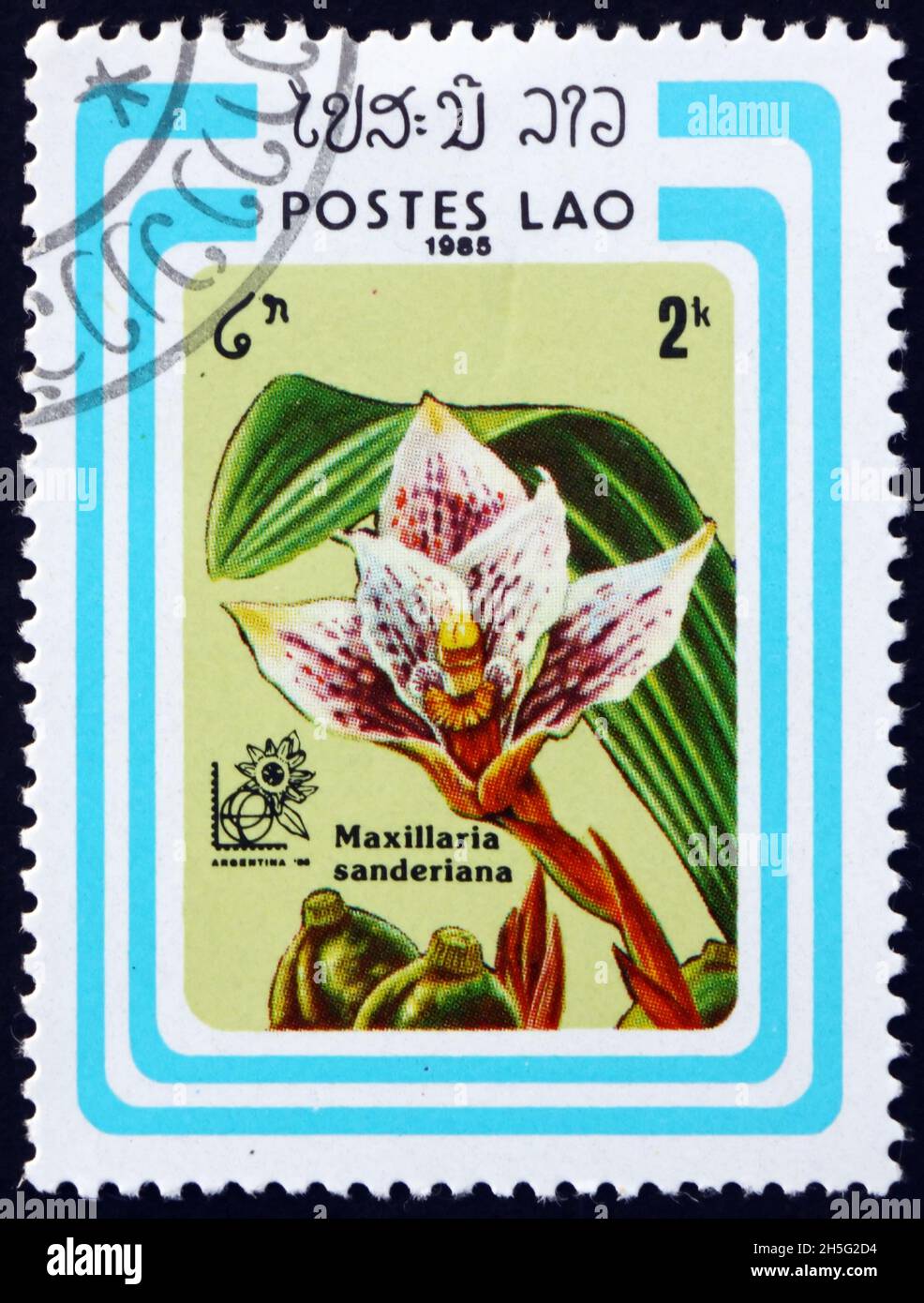 LAOS - CIRCA 1985: a stamp printed in Laos shows sanders maxillaria, maxillaria sanderiana, is a species of orchid found in Ecuador and Peru, circa 19 Stock Photo