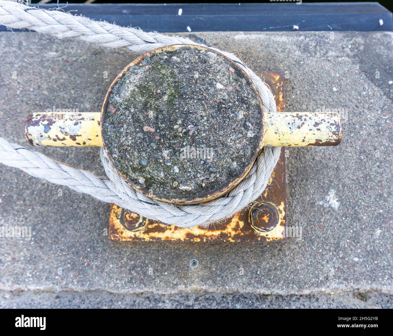 Stockholm, Sweden - April 17, 2021: A view from above on mooring rope around iron bollard Stock Photo