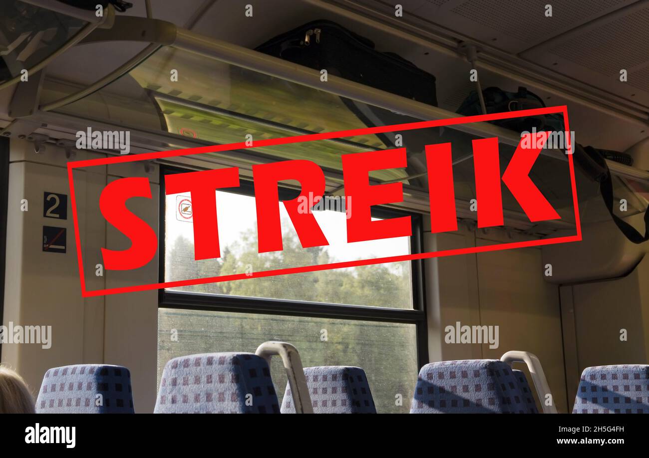 Inside a train with empty seats and German text Streik, meaning strike, political trade union and travel concept, selected focus Stock Photo
