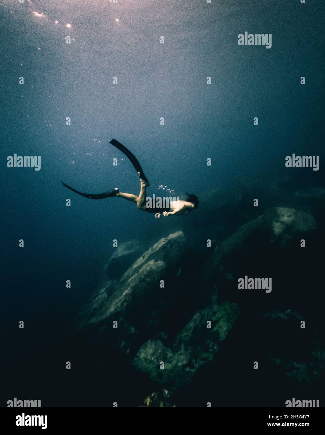 Person diving deep in Mediterranean sea Stock Photo - Alamy