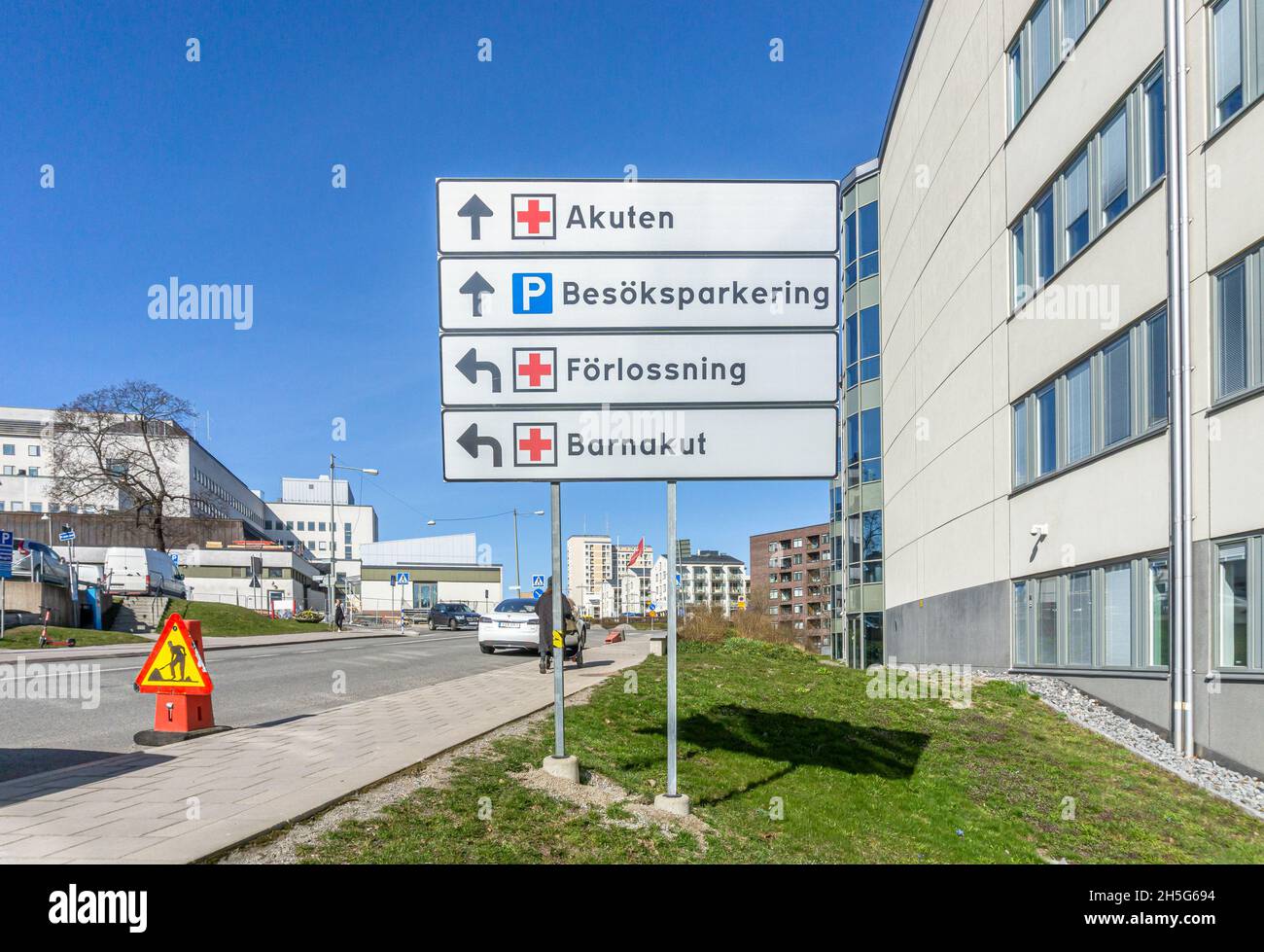Stockholm, Sweden - April 15, 2021: Traffic signs with directions explained at the entrance to hospital area Stock Photo