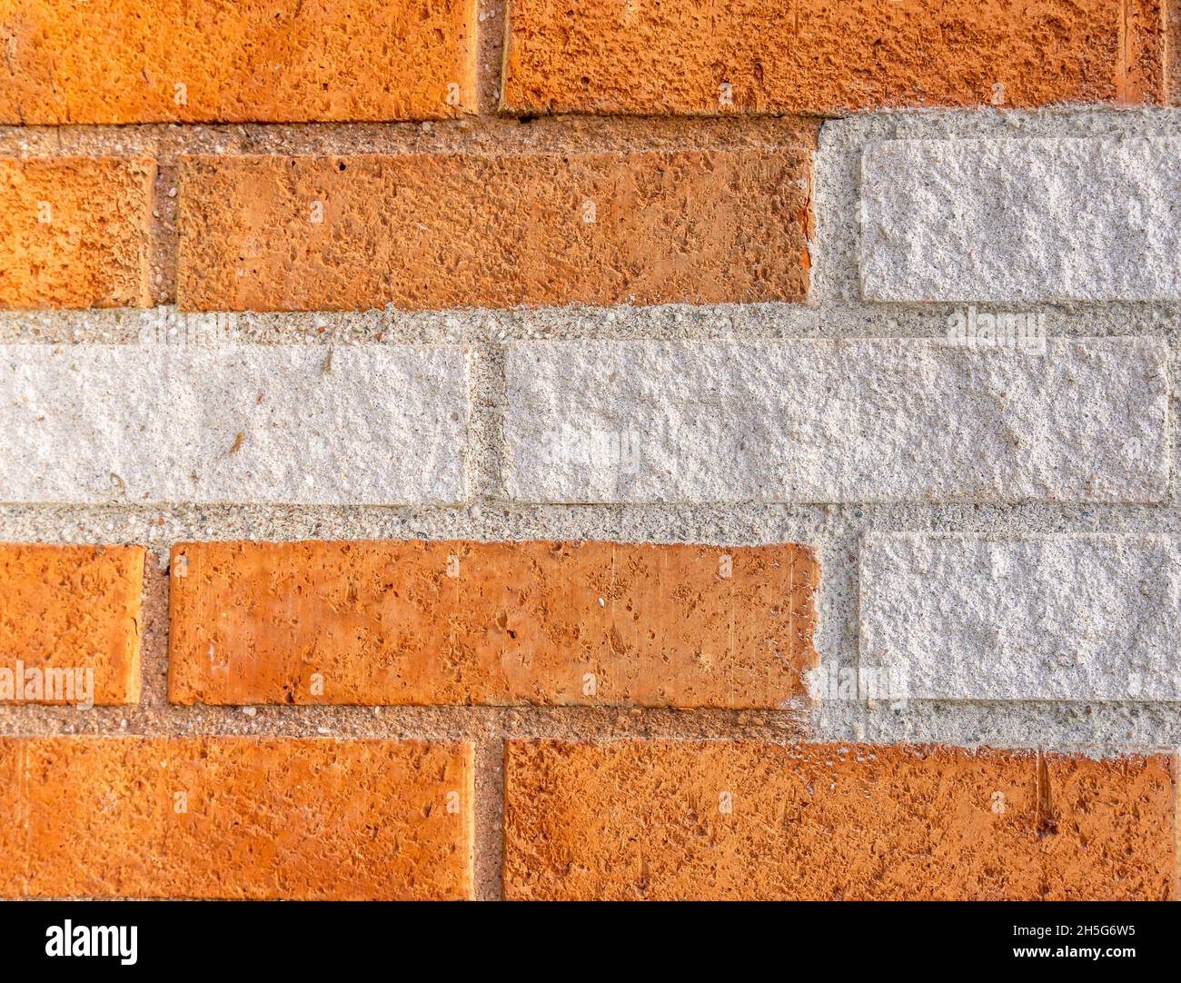Stockholm, Sweden - April 15, 2021: Background with orange bricks in combination with white colored bricks Stock Photo
