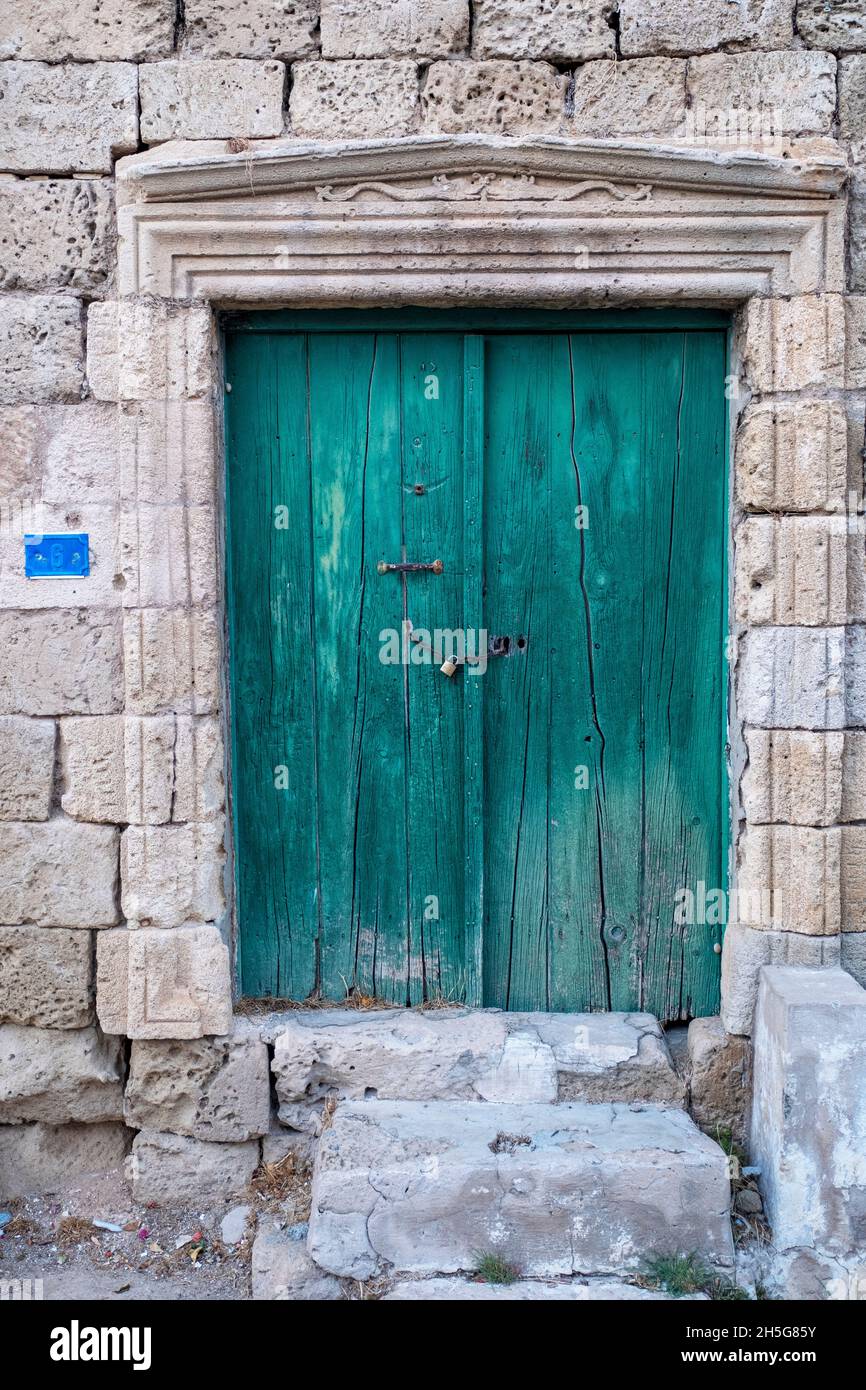 Faded green wooden door Famagusta, Cyprus Stock Photo