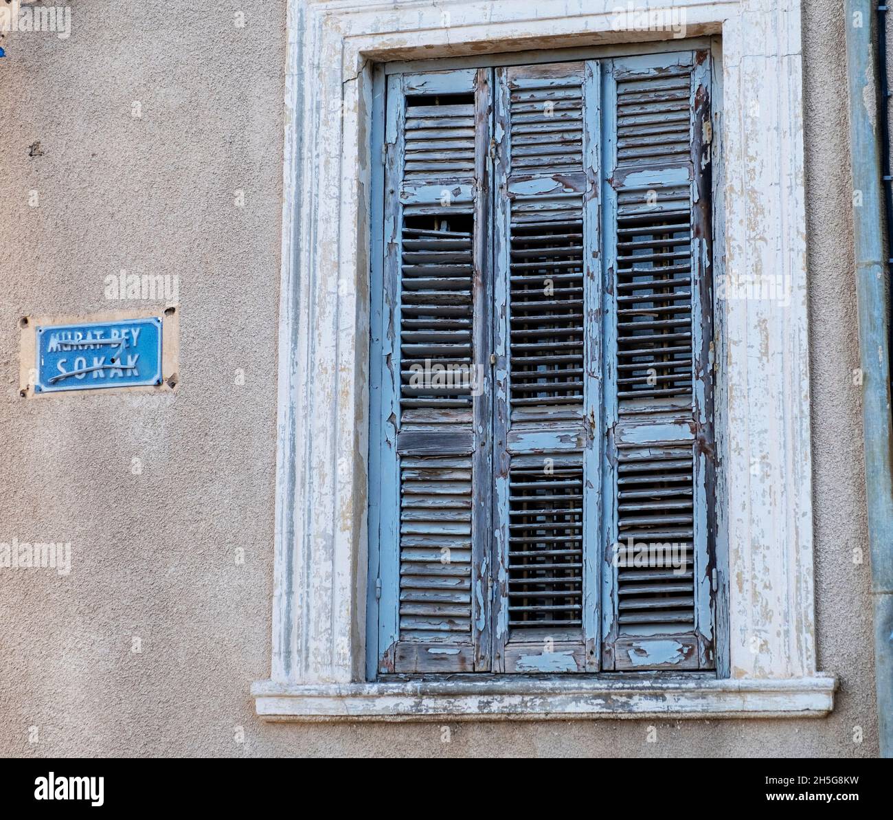 Faded blue window shutters on an abandoned house, Mrat bey Sokak, Famagusta, Cyprus. Stock Photo
