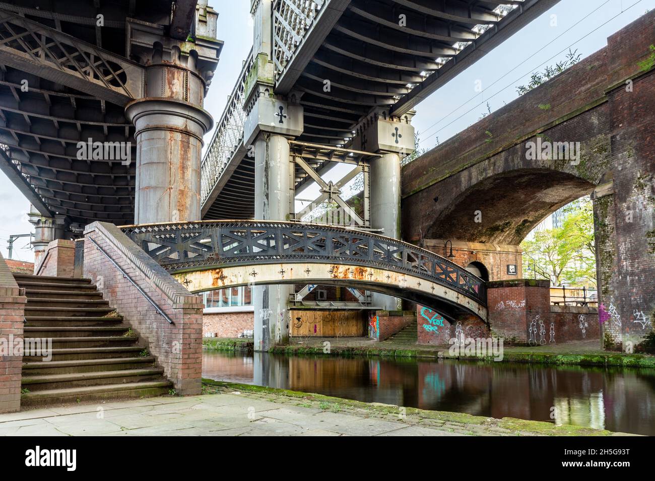 Castlefield urban heritage park. Old & modern railway viaducts and bridges using old (cast iron and brick) and modern steel architecture. Deansgate, M Stock Photo