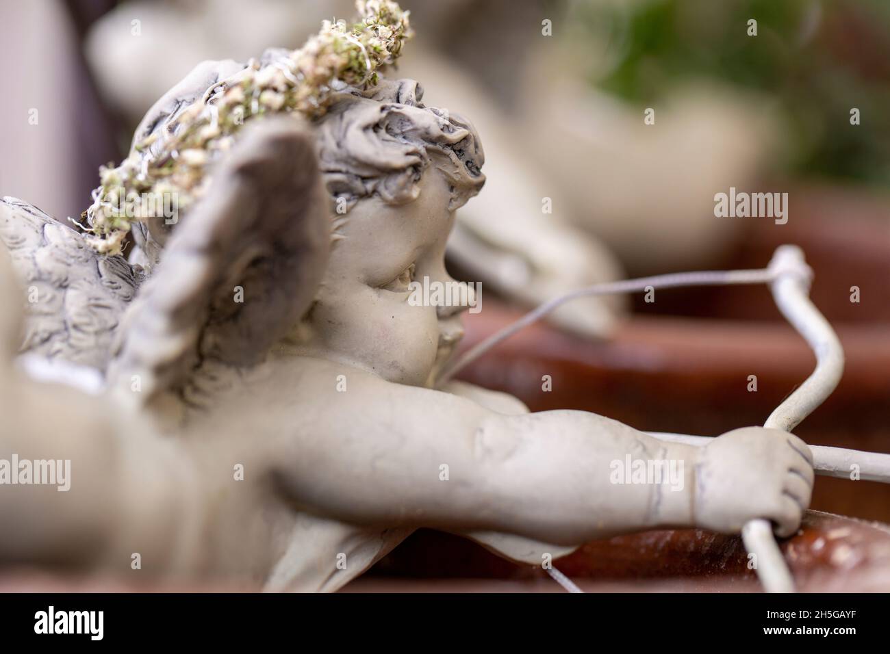 Figurine of amor aiming with bow and arrow Stock Photo