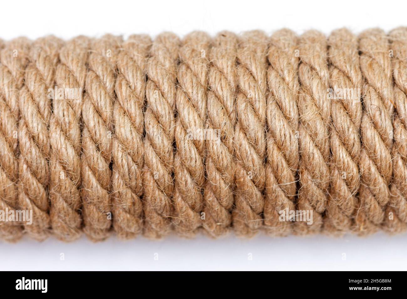 Close-up of sisal rope on white background. Top view, selective focus. Stock Photo