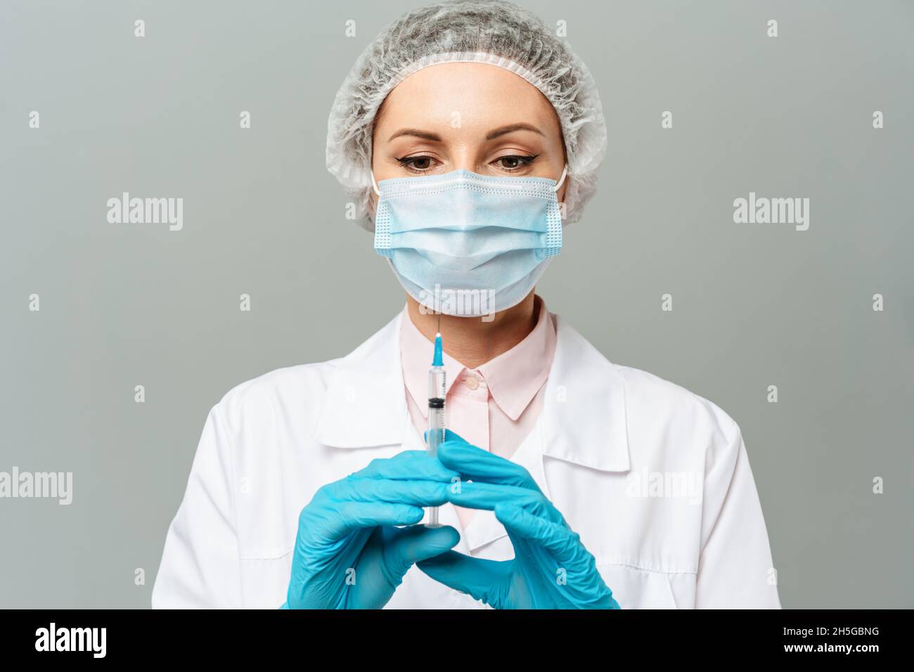 A nurse holds a syringe before making a vaccine against Covid-19 or coronavirus. Stock Photo