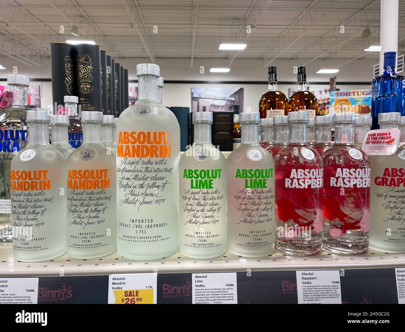 A display of bottles of  flavored Absolut Vodka with background bokeh at a Binneys liqour store in Springfield, Illinois. Stock Photo