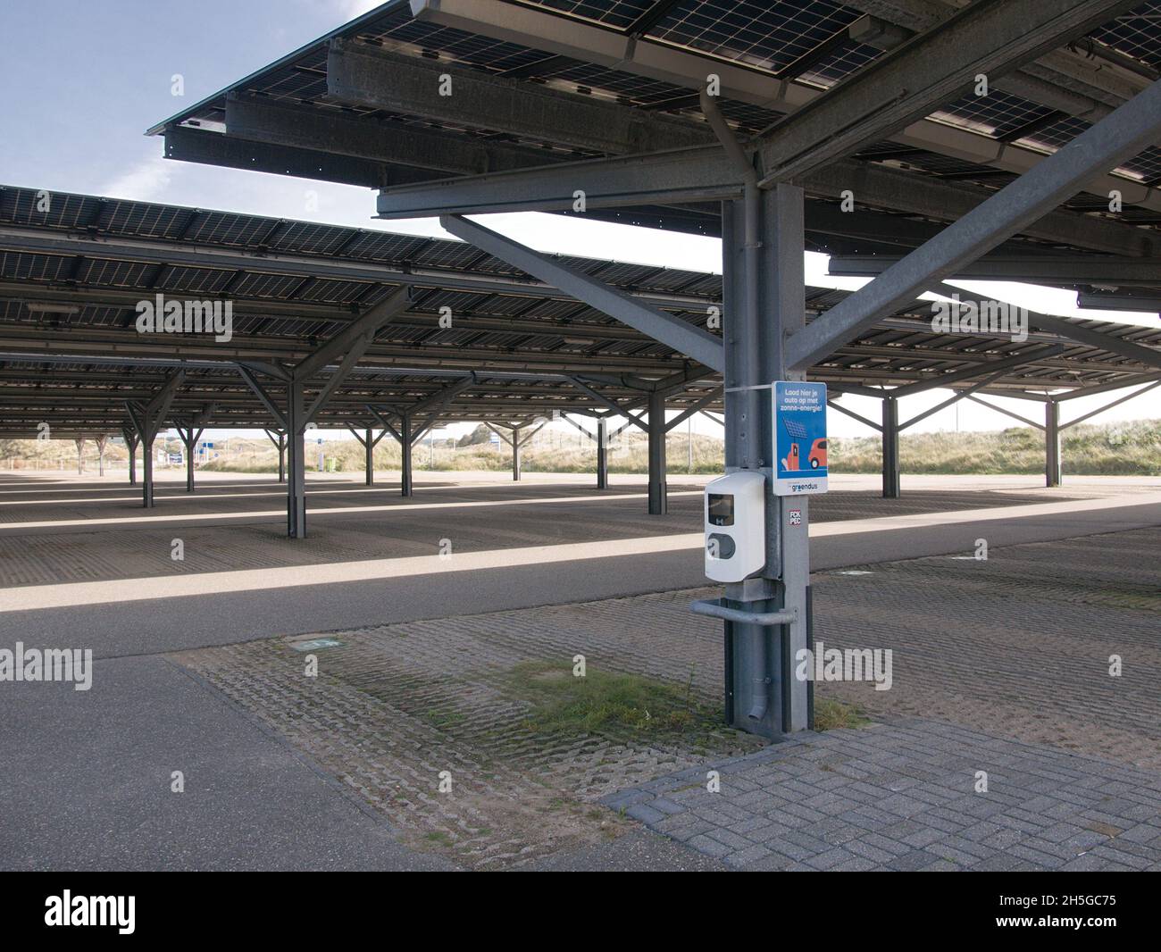 A charge point for electric vehicles under solar panels in a car park in Bloemendaal aan Zee in The Netherlands. Stock Photo