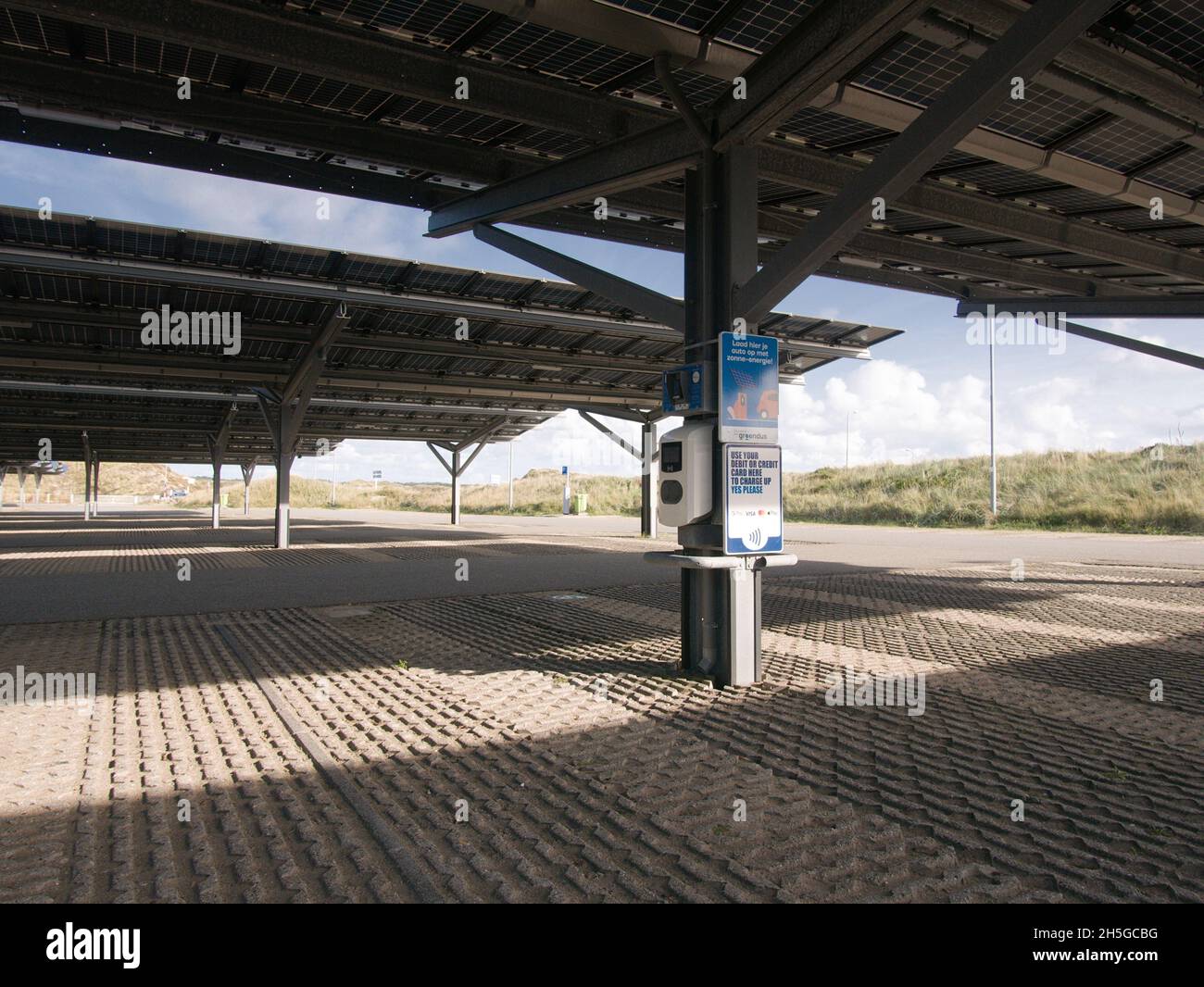 A charge point for electric vehicles under solar panels in a car park in Bloemendaal aan Zee in The Netherlands. Stock Photo